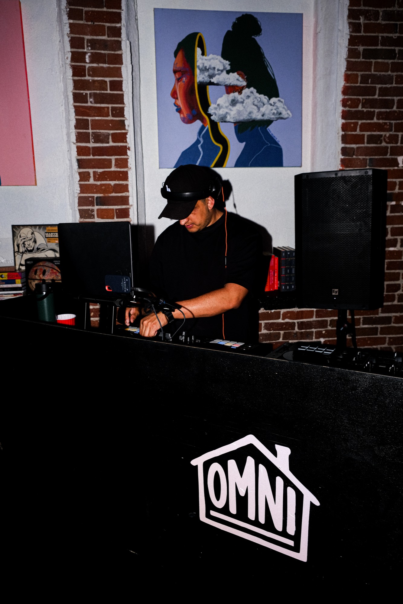 DJ on the main stage with studio signage