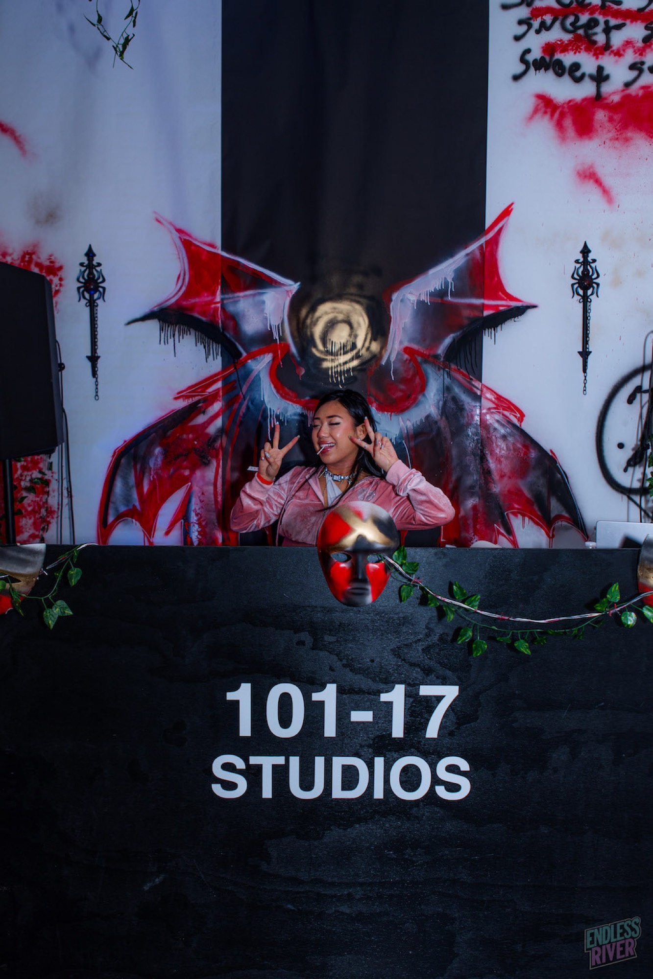 DJ throwing a peace sign at the booth